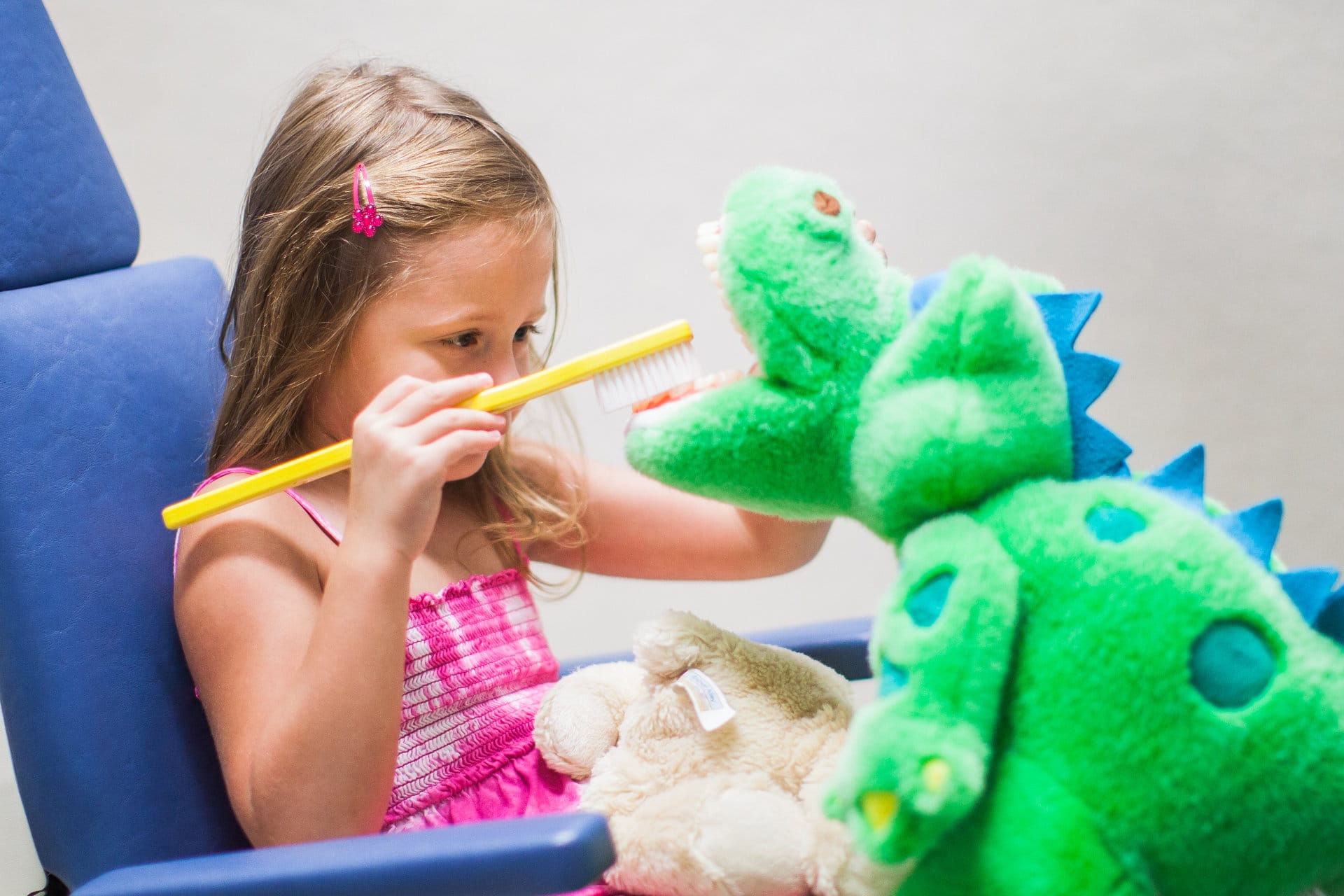 Young child being held during a friendly pediatric dental visit
